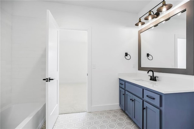 full bath featuring baseboards and vanity