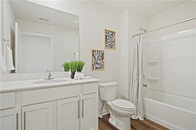 full bathroom with shower / bathtub combination with curtain, vanity, wood-type flooring, and toilet