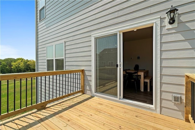 wooden terrace with a lawn