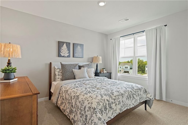 carpeted bedroom featuring multiple windows