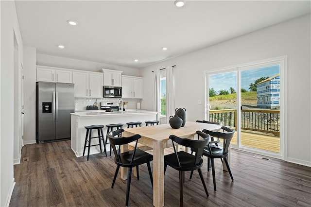 dining space with sink and dark hardwood / wood-style floors