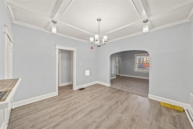 3612 College Ave, Kansas City, MO 64128 - unfurnished dining area with coffered ceiling, a textured ceiling, light wood-type flooring, a notable chandelier, and beamed ceiling