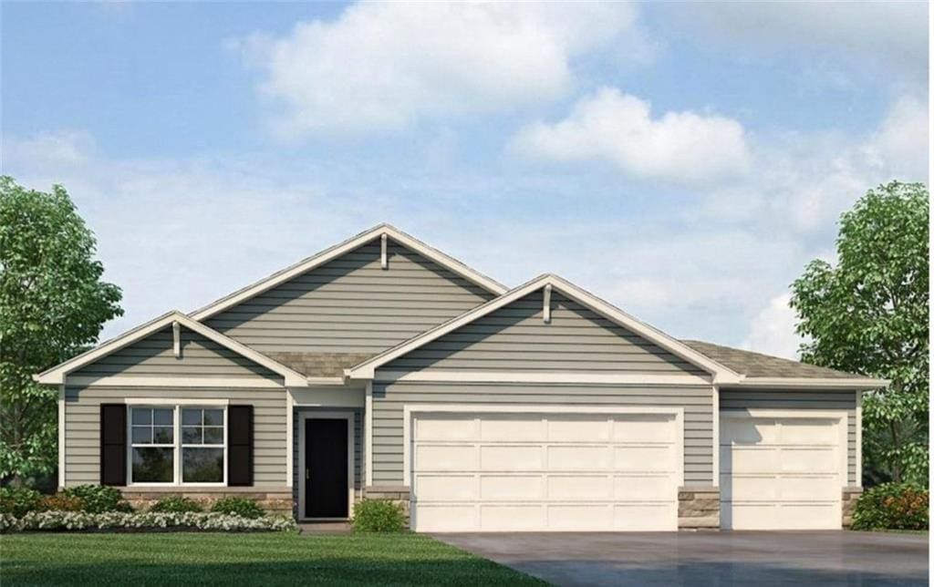 view of front of property with a front yard and a garage