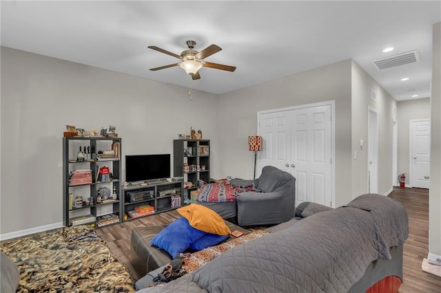 living room featuring hardwood / wood-style floors and ceiling fan