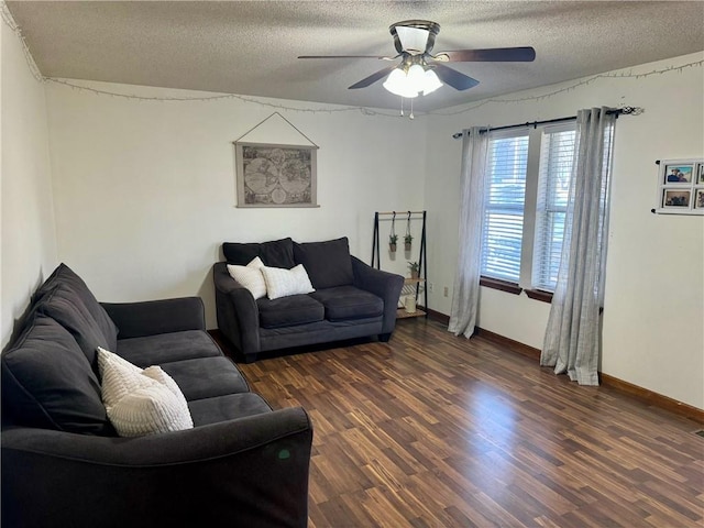 living room with ceiling fan, a textured ceiling, and dark hardwood / wood-style flooring