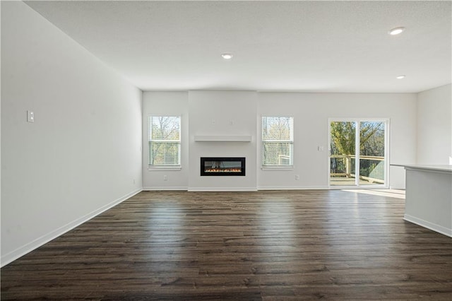 unfurnished living room featuring dark wood-type flooring