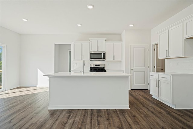 kitchen with white cabinets, dark hardwood / wood-style floors, sink, and stainless steel appliances