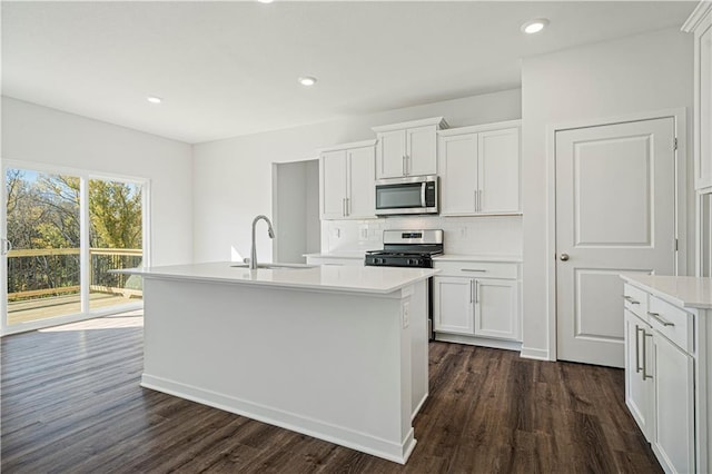 kitchen with sink, white cabinets, and appliances with stainless steel finishes