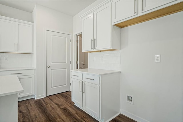 kitchen with white cabinets, backsplash, and dark wood-type flooring