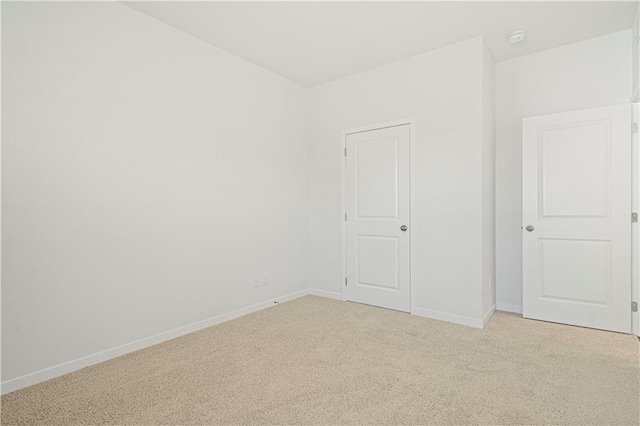 empty room featuring light colored carpet