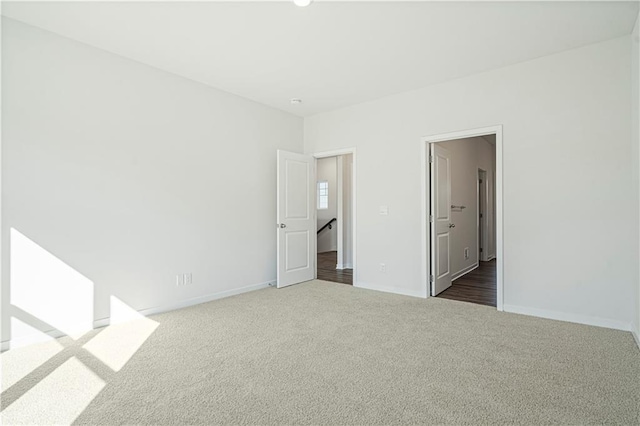 empty room featuring dark colored carpet