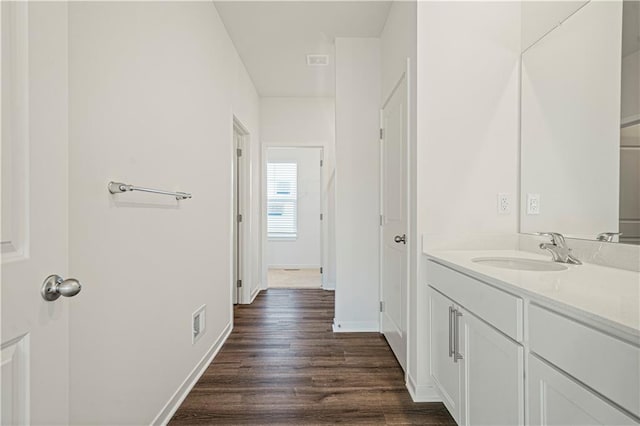 bathroom with hardwood / wood-style flooring and vanity