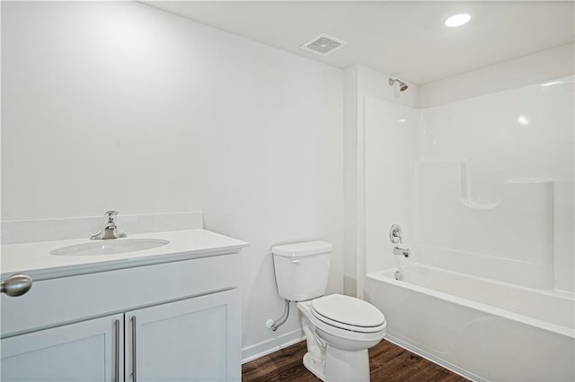 full bathroom with hardwood / wood-style flooring, vanity, toilet, and tub / shower combination