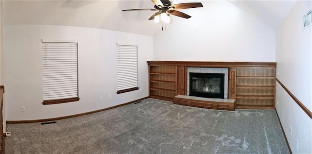 unfurnished living room with carpet, a tile fireplace, lofted ceiling, and ceiling fan