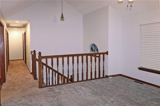 interior space featuring light colored carpet and lofted ceiling