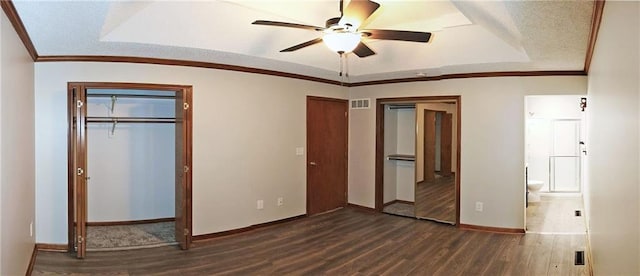 unfurnished bedroom with dark hardwood / wood-style floors, ceiling fan, a raised ceiling, and lofted ceiling