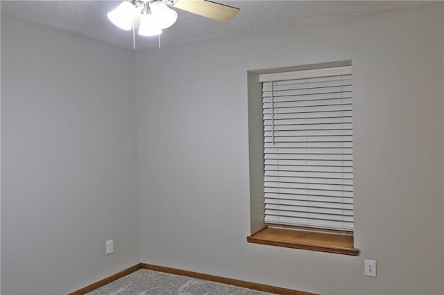 empty room featuring ceiling fan and a textured ceiling