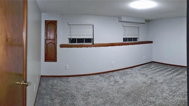 empty room with a wall mounted AC and carpet