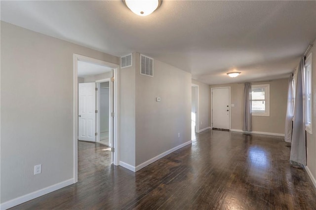 spare room with dark hardwood / wood-style floors