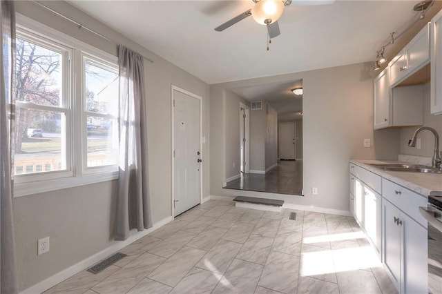 bathroom featuring ceiling fan and sink