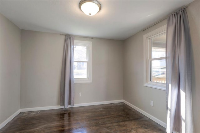 unfurnished room with dark hardwood / wood-style floors