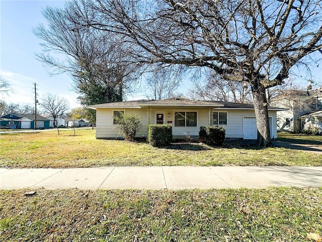 ranch-style home with a garage and a front lawn