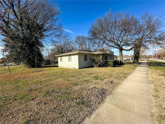 view of property exterior featuring a lawn