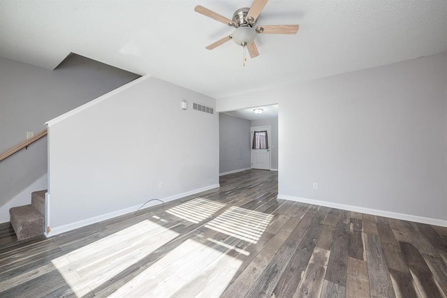 unfurnished room with ceiling fan and dark hardwood / wood-style flooring