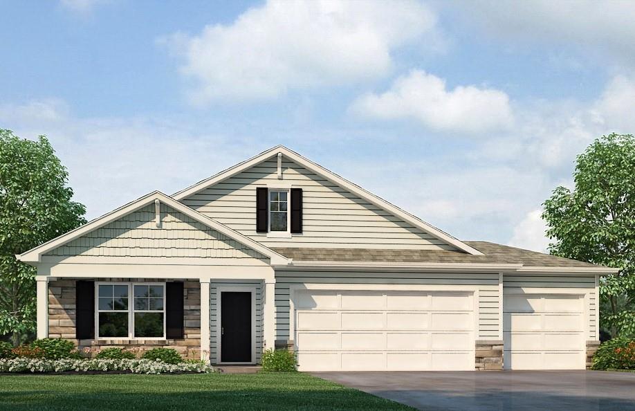 view of front of house with a garage and a front lawn