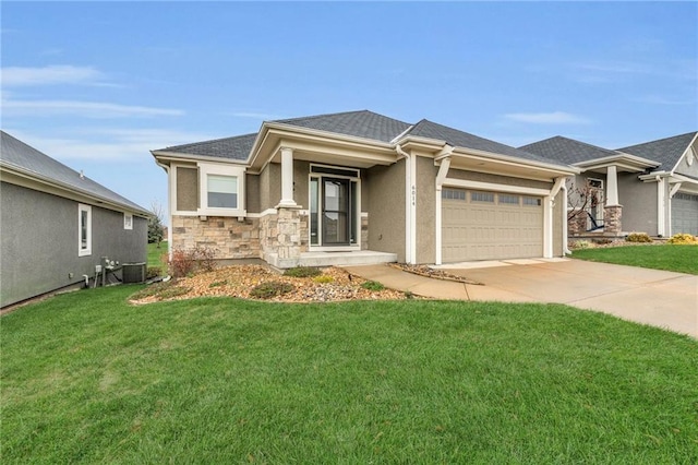 view of front facade with central AC, a garage, and a front lawn