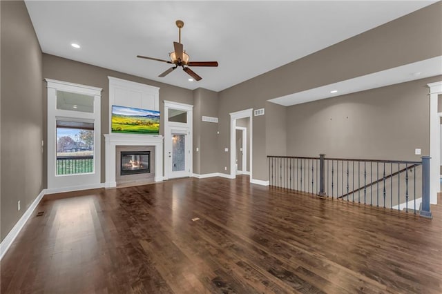 unfurnished living room featuring hardwood / wood-style floors and ceiling fan