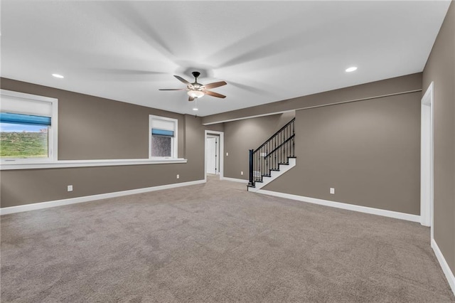 interior space with carpet and ceiling fan