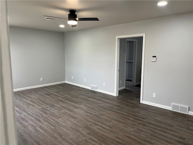 empty room with dark hardwood / wood-style floors and ceiling fan