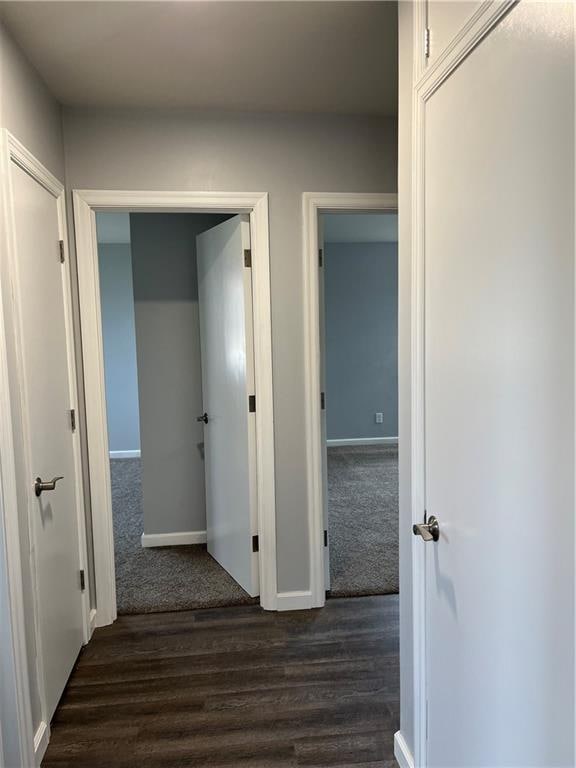 hallway with dark hardwood / wood-style floors