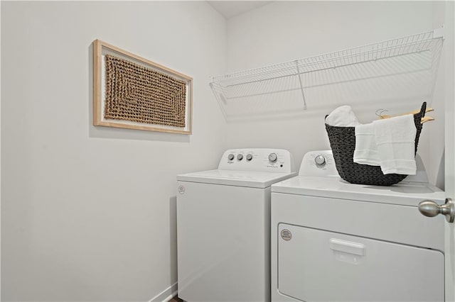 clothes washing area featuring washer and clothes dryer