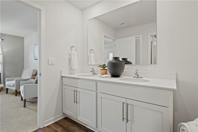 bathroom with hardwood / wood-style floors and vanity