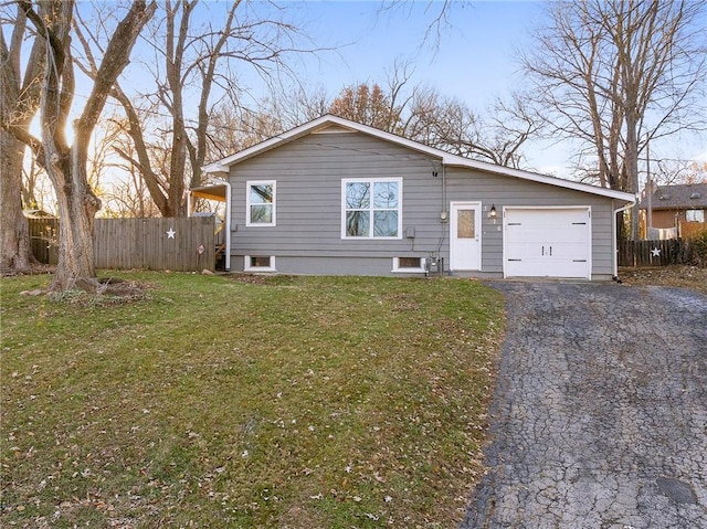 view of front of home featuring a garage and a front lawn