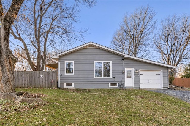 view of front of home with a front yard and a garage