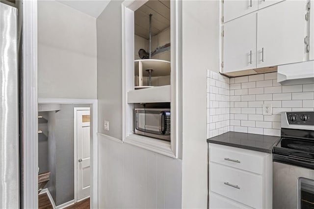 kitchen with tasteful backsplash, ventilation hood, dark wood-type flooring, electric stove, and white cabinetry