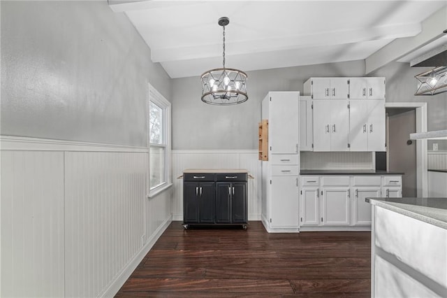 kitchen with dark wood-type flooring, hanging light fixtures, vaulted ceiling with beams, white cabinetry, and a chandelier