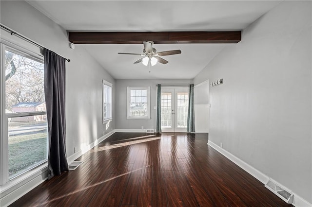 unfurnished room featuring french doors, lofted ceiling with beams, a wealth of natural light, and dark wood-type flooring