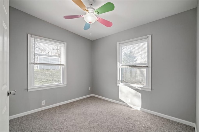 spare room with carpet flooring, plenty of natural light, and ceiling fan