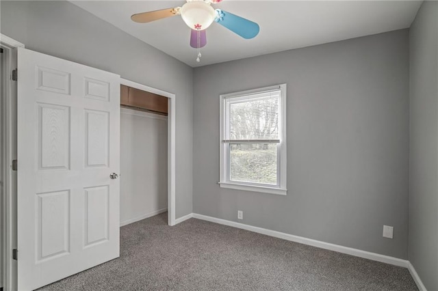 unfurnished bedroom featuring ceiling fan, light colored carpet, and a closet