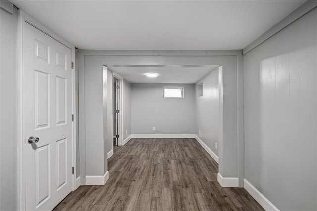 basement with dark hardwood / wood-style floors