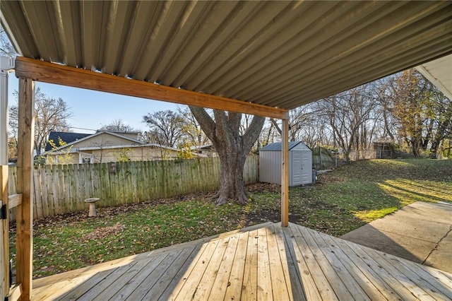 wooden terrace with a lawn and a storage shed