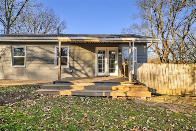 rear view of property with a deck and french doors