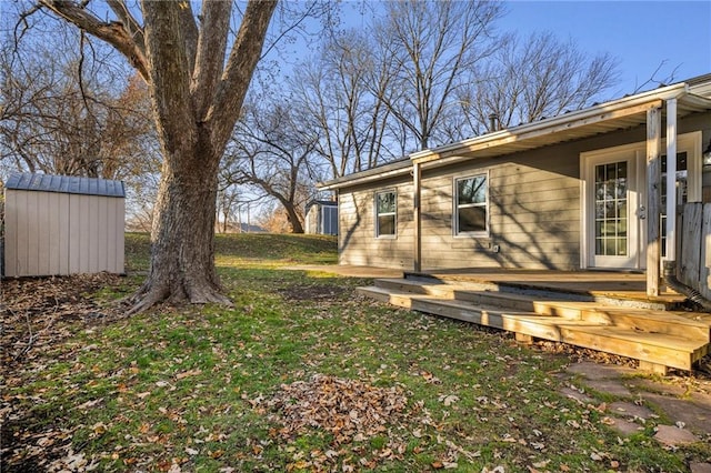 view of yard with a deck and a storage unit