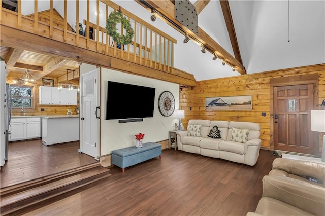 living room with beamed ceiling, dark hardwood / wood-style flooring, and wood walls