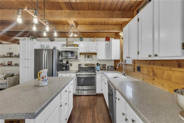 kitchen featuring sink, beamed ceiling, decorative light fixtures, dark hardwood / wood-style flooring, and stainless steel appliances