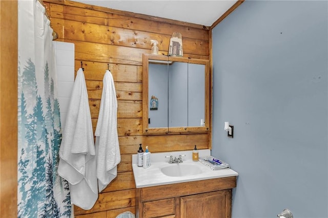 bathroom with vanity and wooden walls